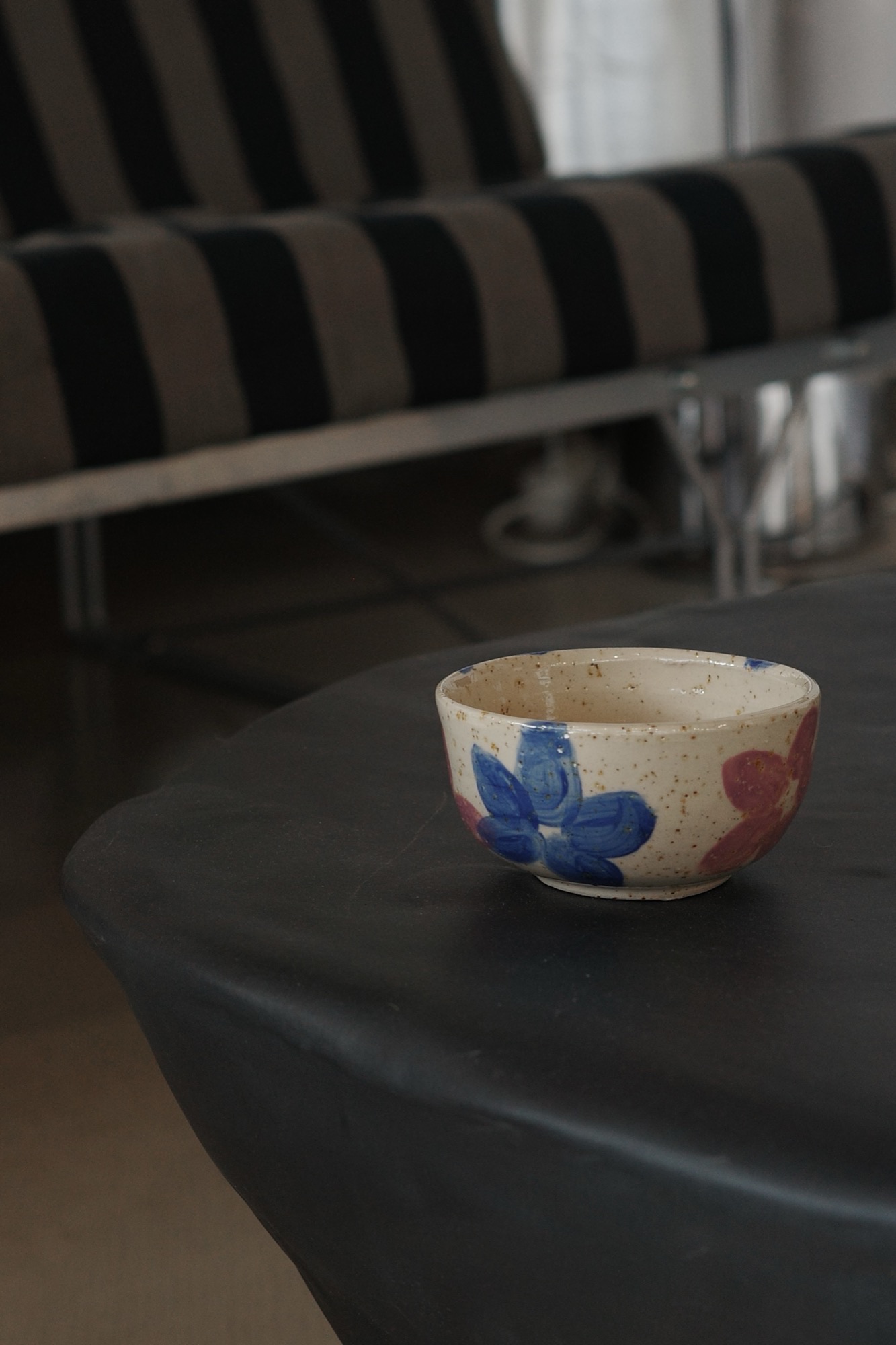 Flower-painted bowl on a black table