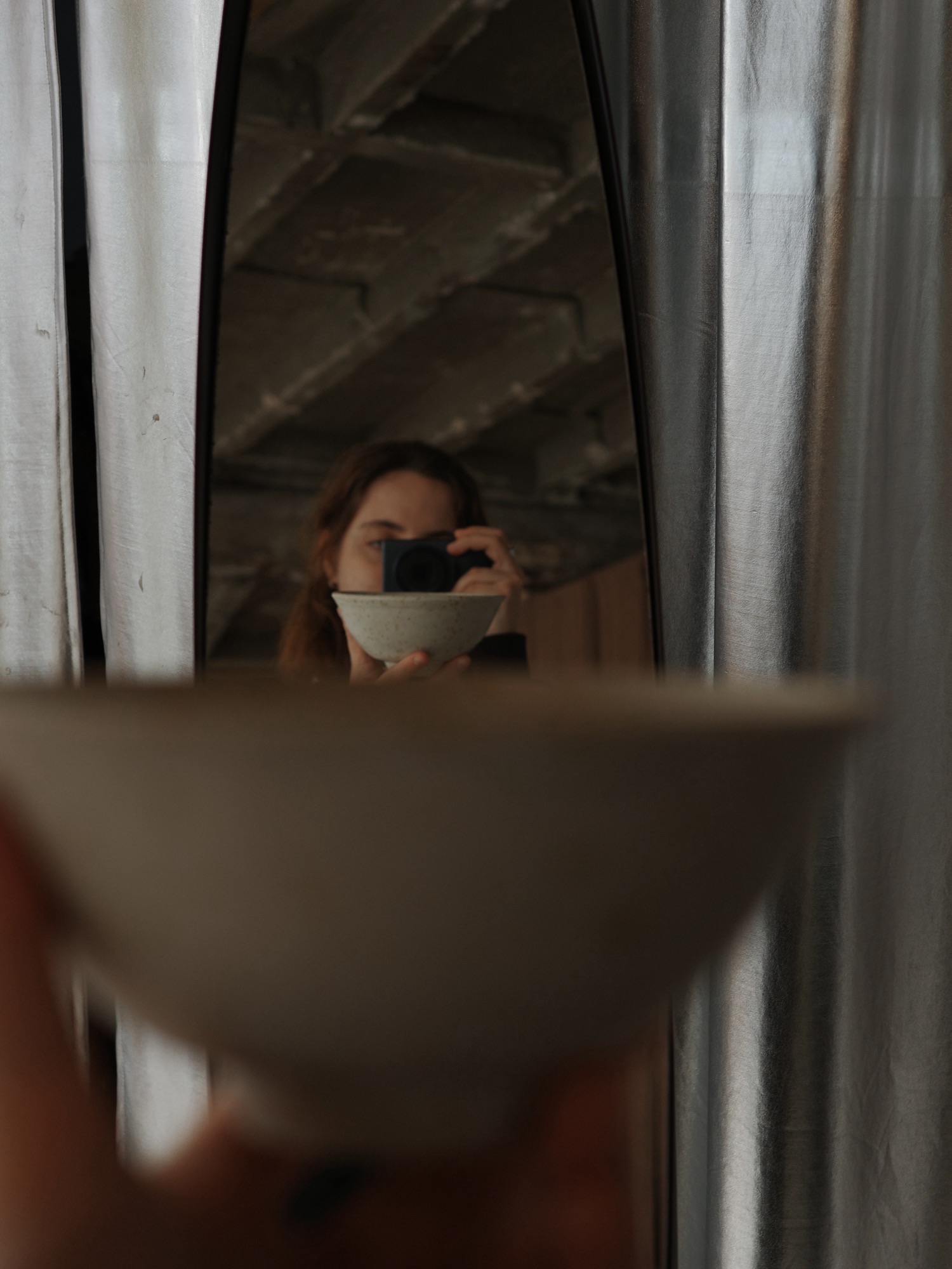 Holding a speckled bowl up to a mirror